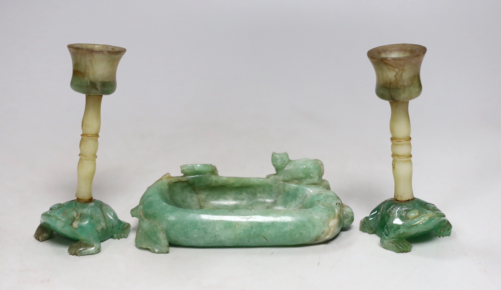 A pair of Chinese jade stemmed and green quartz candlesticks and a green quartz brushwasher, 12cms wide (3)